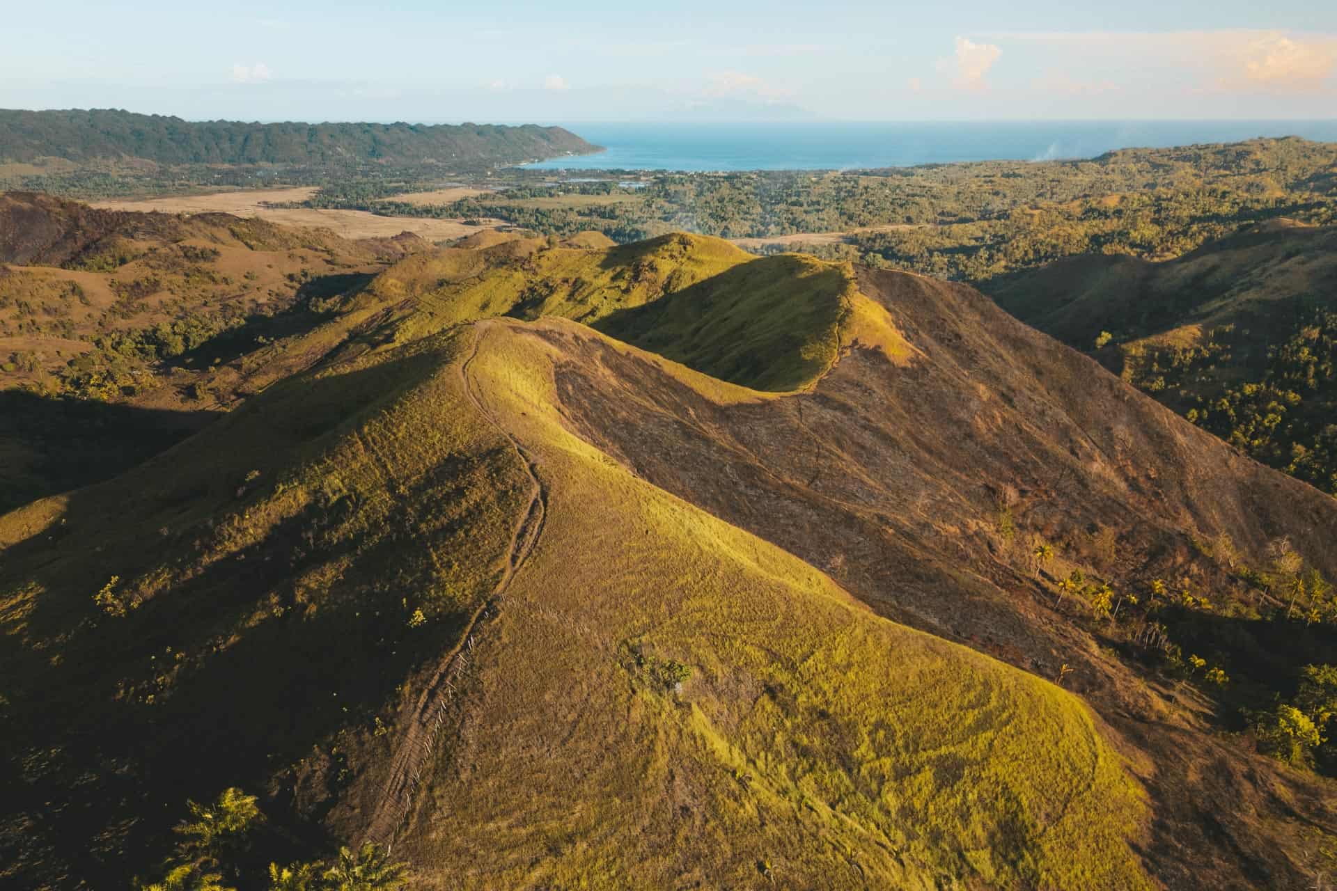 Sweeping view of Kankoka Hills with green mountain slopes and the Candijay landscape in the background