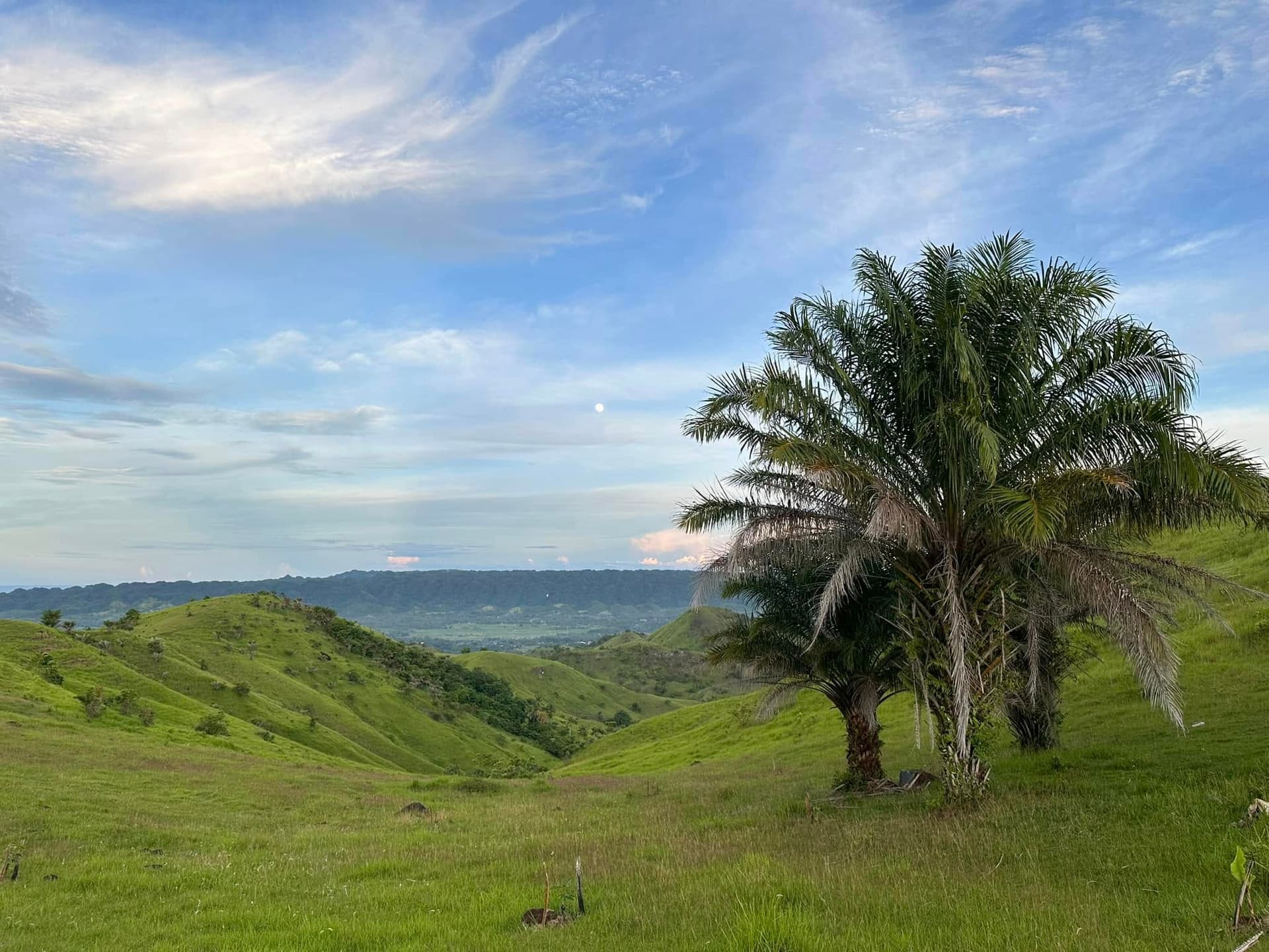Sunlight and cloud shadows creating patterns across the hill ridges