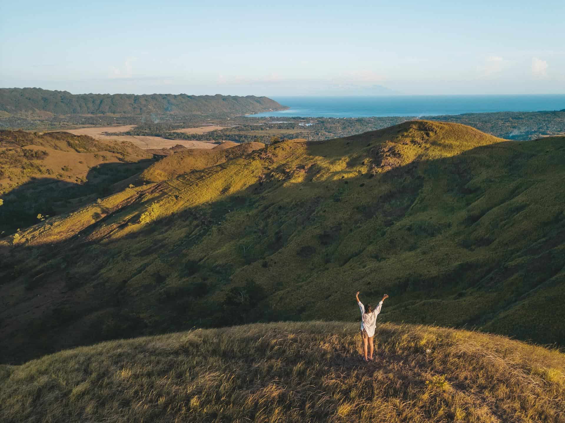 Visitors standing at the summit of Kankoka Hills taking in the sweeping panoramic view of Candijay, Bohol